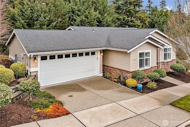 ranch-style home with stone siding, an attached garage, roof with shingles, and driveway