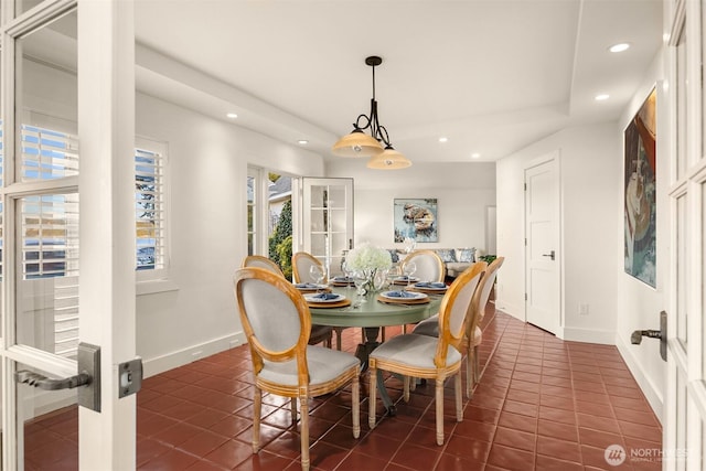 dining area with dark tile patterned floors, recessed lighting, and baseboards