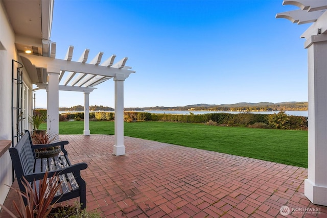 view of patio featuring a pergola and a water view