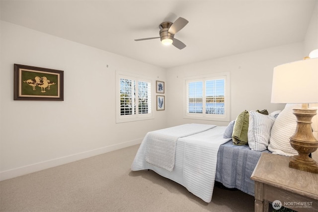 carpeted bedroom with baseboards and a ceiling fan