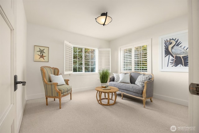 sitting room with baseboards, carpet floors, and a healthy amount of sunlight