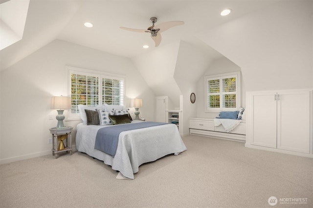 bedroom featuring light carpet, multiple windows, and lofted ceiling