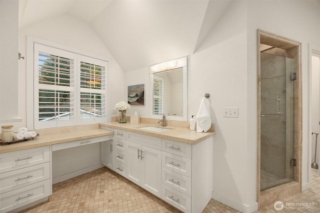 full bath featuring baseboards, vanity, a shower stall, and vaulted ceiling