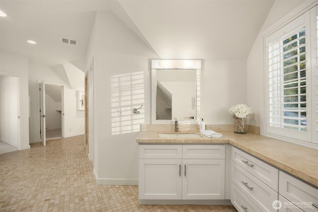 bathroom with visible vents, recessed lighting, baseboards, vanity, and vaulted ceiling