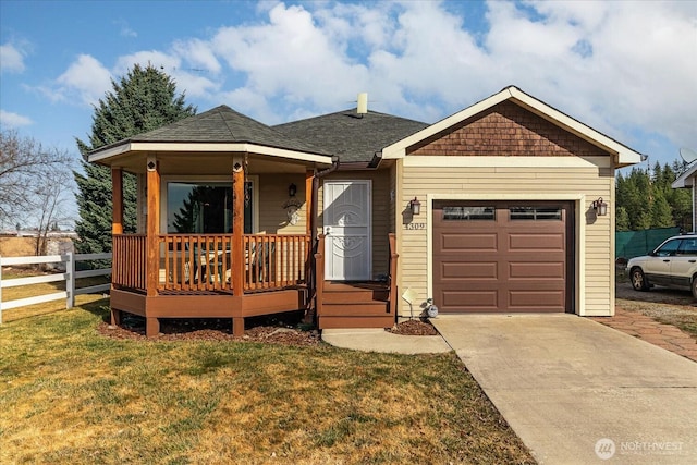 view of front of property with a front lawn, driveway, fence, roof with shingles, and a garage