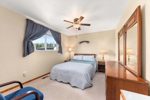 carpeted bedroom with visible vents, ceiling fan, and baseboards