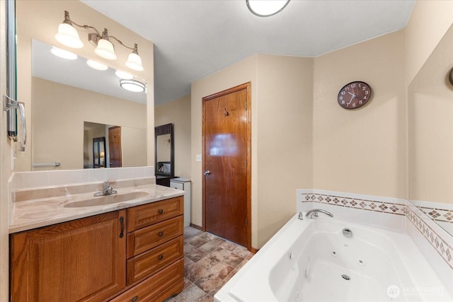 full bathroom featuring vanity and a jetted tub