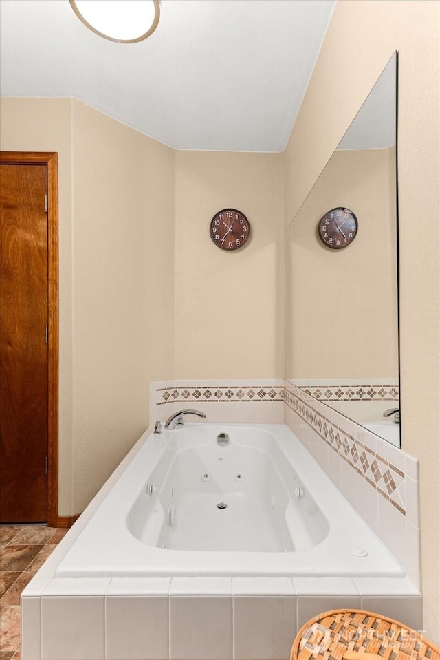 full bathroom featuring a tub with jets