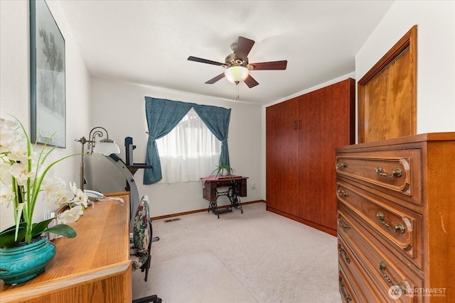 office with light carpet, visible vents, ceiling fan, and baseboards