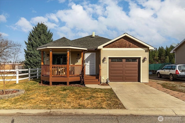 view of front facade with fence, driveway, roof with shingles, a front lawn, and a garage