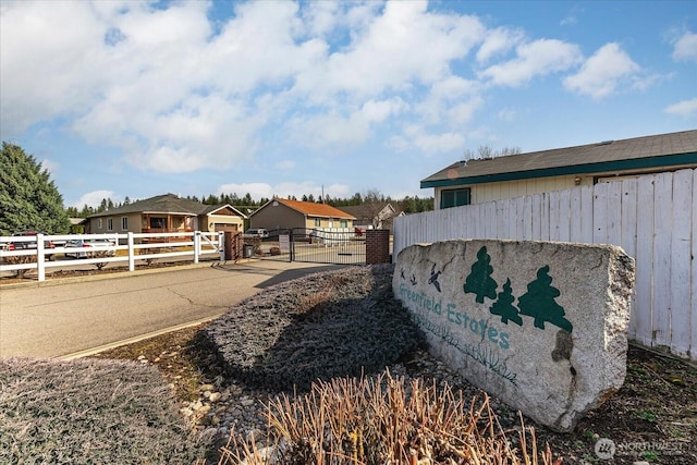 view of side of property featuring a gate and fence