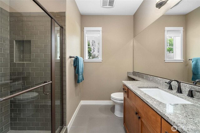 14317 Knoll Park Dr E, Bonney Lake, WA 98391 - bathroom featuring vanity, toilet, a shower stall, baseboards, and tile patterned flooring
