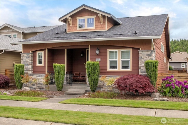 14317 Knoll Park Dr E, Bonney Lake, WA 98391 - view of front of home featuring stone siding, a porch, and roof with shingles