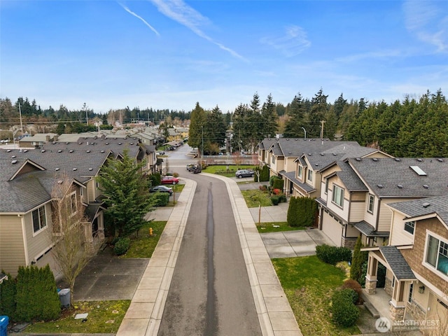 view of road featuring a residential view and curbs