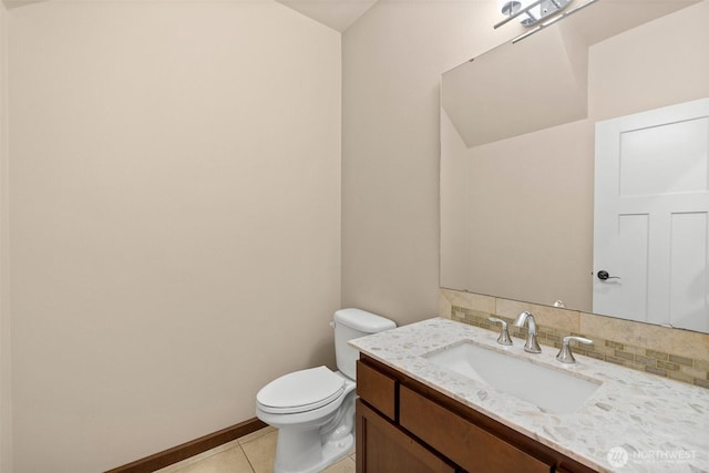 half bathroom featuring baseboards, toilet, decorative backsplash, tile patterned floors, and vanity