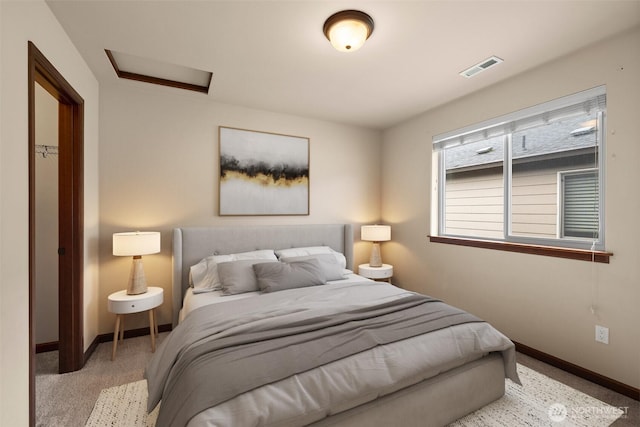 bedroom featuring visible vents, attic access, and baseboards