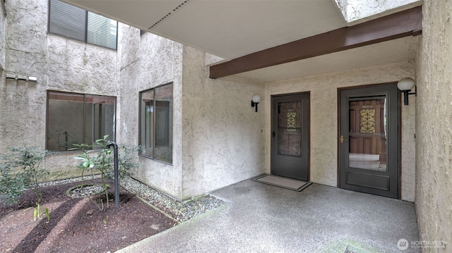 doorway to property with stucco siding