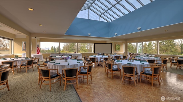 dining room featuring recessed lighting and a high ceiling