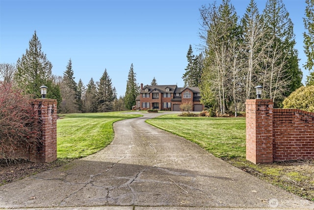 tudor home featuring a front yard and a chimney