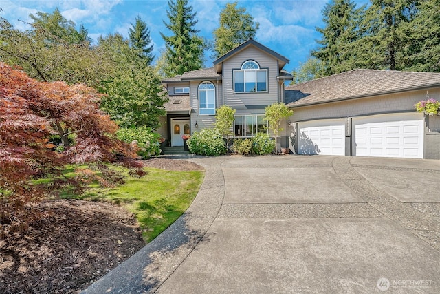 view of front of home with an attached garage and concrete driveway