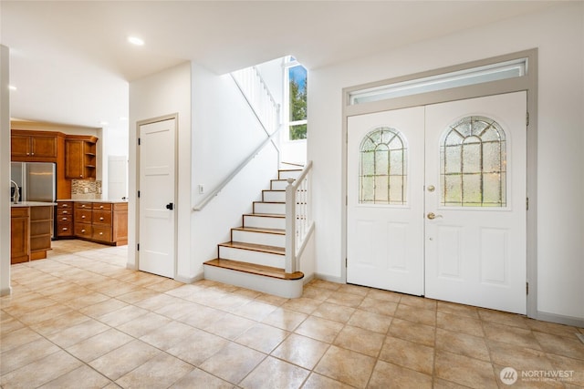 foyer with recessed lighting, french doors, stairs, and baseboards