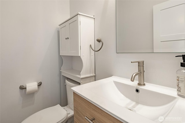 bathroom featuring vanity and toilet