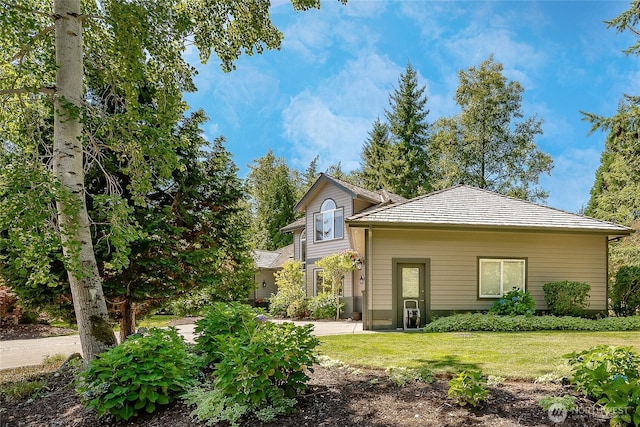 rear view of house with a lawn