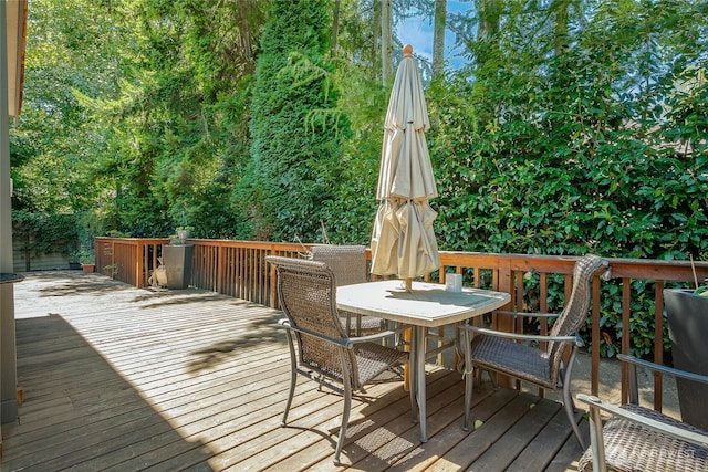 wooden deck featuring outdoor dining area