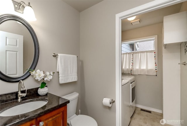 bathroom featuring tile patterned flooring, visible vents, washer and clothes dryer, toilet, and vanity