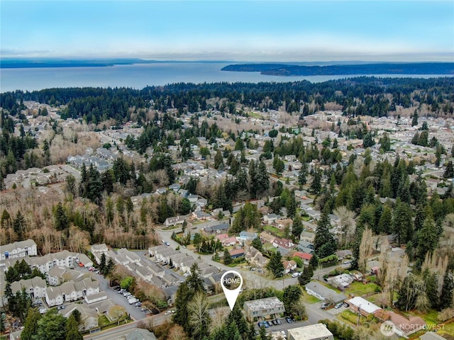 drone / aerial view with a water view and a wooded view