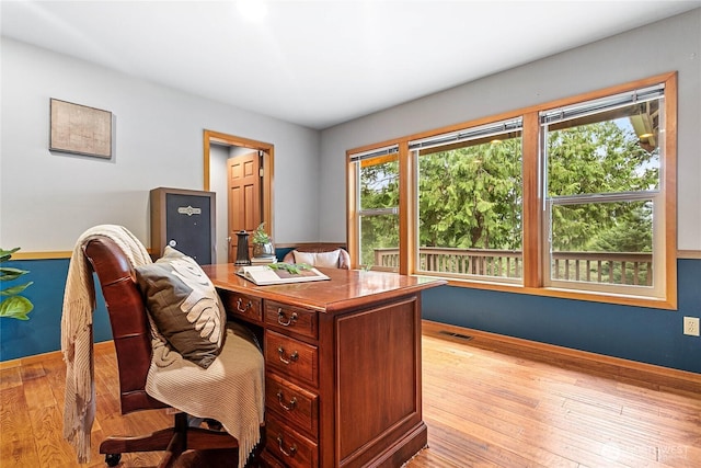 home office featuring visible vents and hardwood / wood-style flooring