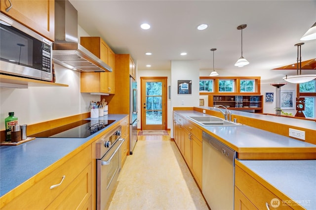 kitchen featuring island exhaust hood, decorative light fixtures, a sink, recessed lighting, and stainless steel appliances