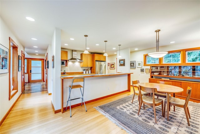 dining space featuring recessed lighting, light wood-type flooring, and baseboards