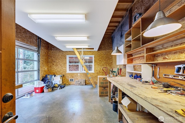 interior space with hanging light fixtures, open shelves, visible vents, and finished concrete floors