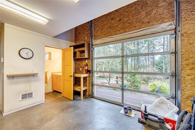 misc room with visible vents, a healthy amount of sunlight, and concrete floors