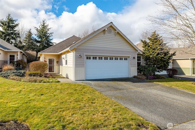 ranch-style house featuring an attached garage, a shingled roof, driveway, and a front lawn