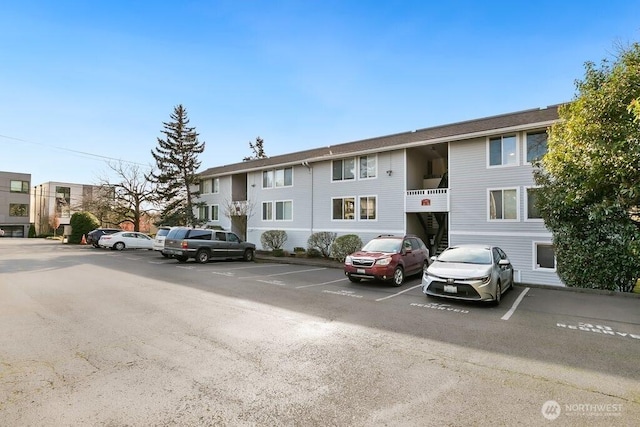 view of building exterior with uncovered parking