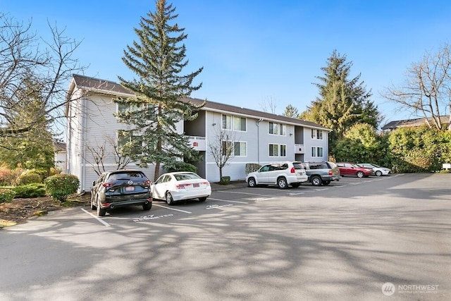 view of building exterior featuring uncovered parking