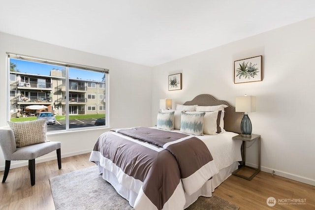 bedroom featuring wood finished floors and baseboards