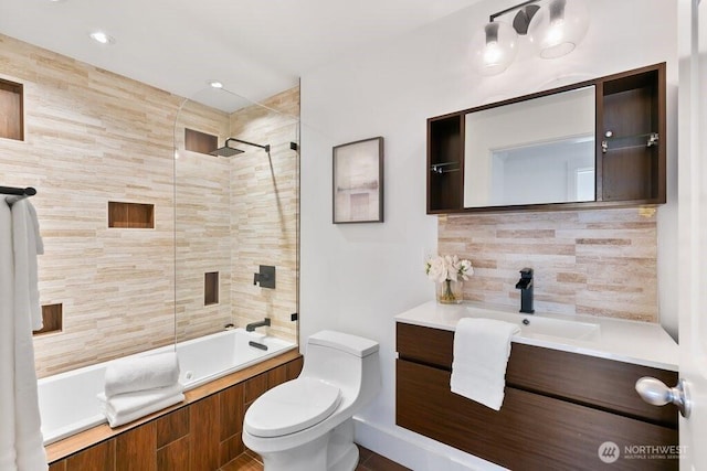 bathroom featuring shower / bath combination, tasteful backsplash, toilet, and vanity