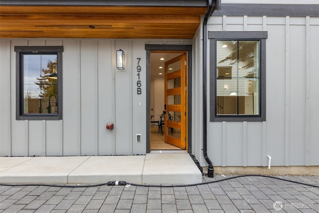 property entrance featuring board and batten siding