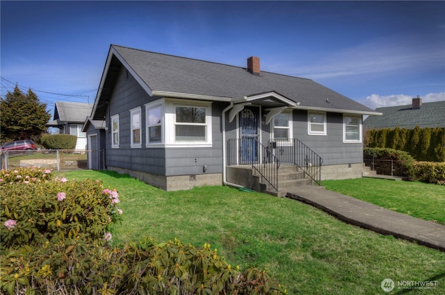 bungalow-style home featuring crawl space, a front yard, and fence