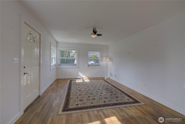 entryway with baseboards, a ceiling fan, and wood finished floors