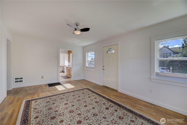 entryway with baseboards, ceiling fan, and wood finished floors