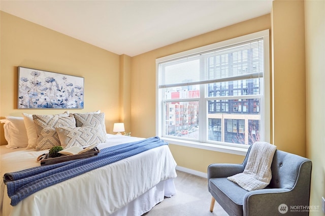 carpeted bedroom featuring baseboards