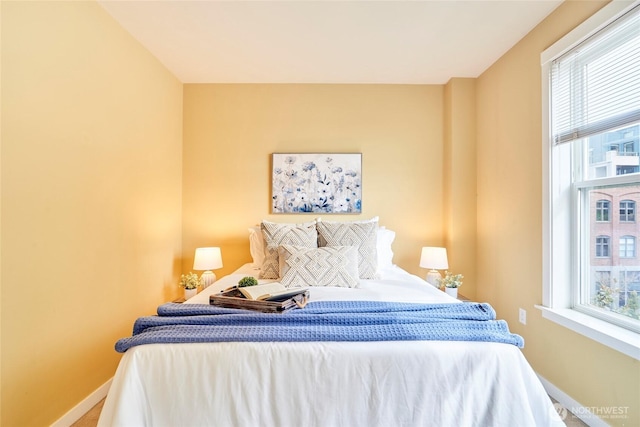 bedroom featuring multiple windows and baseboards