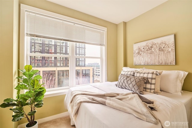 bedroom with baseboards and carpet