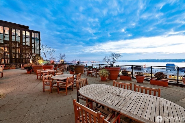 view of patio featuring outdoor dining area and a water view