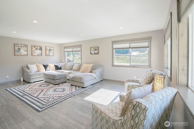 living room with recessed lighting, wood finished floors, and baseboards