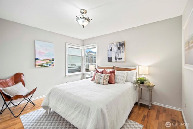 bedroom featuring wood finished floors and baseboards